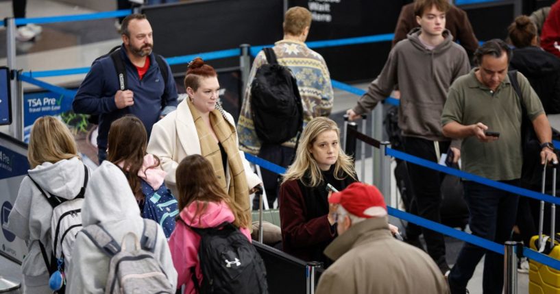 Travelers wait in line at a security checkpoint at O'Hare International Airport in Chicago, Illinois, on November 22, 2024, ahead of the Thanksgiving holiday.