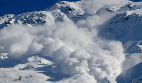 This image shows an avalanche descending down a mountain.