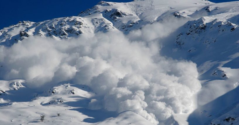 This image shows an avalanche descending down a mountain.