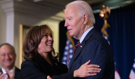 President Joe Biden, right, embraces Vice President Kamala Harris during the Democratic National Committee's Holiday Reception in Washington, D.C., on Dec. 15.