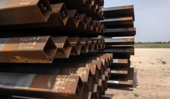 Unused pieces of steel bollard-style wall lie near a portion of unfinished border wall in La Joya, Texas, at the U.S.-Mexico border in a file photo from April 14, 2021. President-elect Donald Trump has filed a brief supporting a suit to halt the Biden administration from selling off the materials for pennies on the dollar.