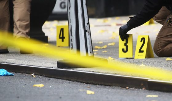 Police place bullet casing markers outside of a Hilton Hotel in Midtown Manhattan where United Healthcare CEO Brian Thompson was fatally shot on Wednesday.