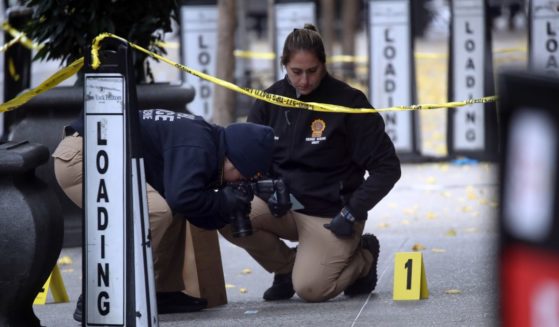 Police place bullet casing markers outside of a Hilton Hotel in Midtown Manhattan where United Healthcare CEO Brian Thompson was fatally shot on Wednesday.