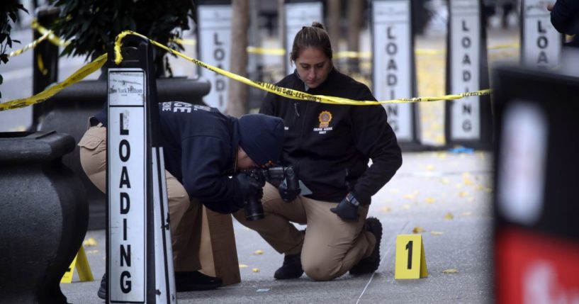 Police place bullet casing markers outside of a Hilton Hotel in Midtown Manhattan where United Healthcare CEO Brian Thompson was fatally shot on Wednesday.