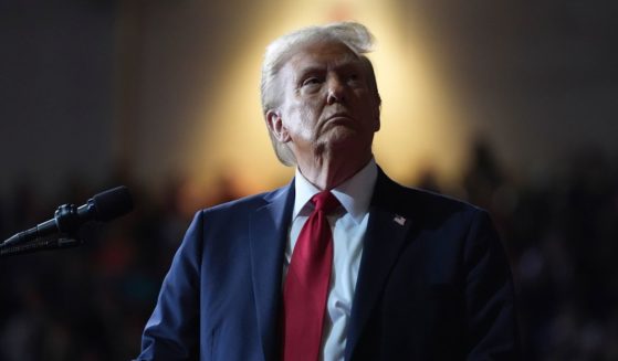 Then-Republican presidential nominee Donald Trump watches a screen during a campaign rally in Salem, Virginia, on Nov. 2.