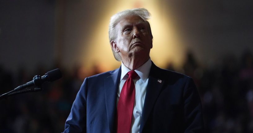 Then-Republican presidential nominee Donald Trump watches a screen during a campaign rally in Salem, Virginia, on Nov. 2.