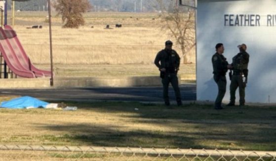 Law enforcement officials stand outside Feather River School of Seventh-Day Adventists in Palermo, California, following a shooting on Wednesday that left two children seriously injured and the gunman dead.