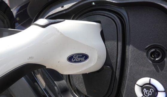 An electric vehicle is charged at the Golf Mill Ford dealership in Niles, Illinois, on July 18, 2023.