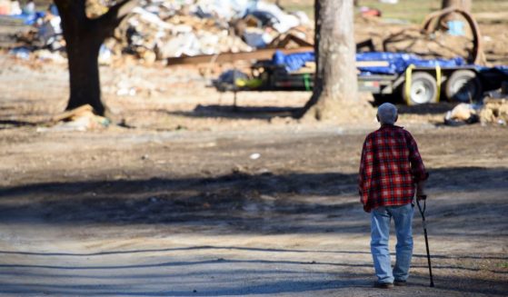 Paul Cole walks along his street in Lake Lure, North Carolina, where debris and destruction from Hurricane Helene is seen on Dec. 23.