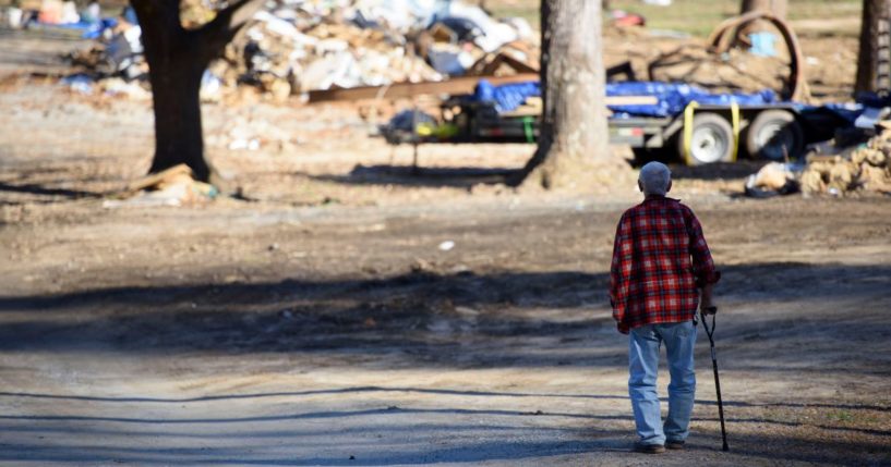 Paul Cole walks along his street in Lake Lure, North Carolina, where debris and destruction from Hurricane Helene is seen on Dec. 23.