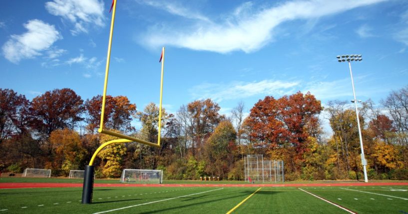 A high school football field in the autumn.