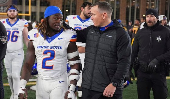 Boise State head coach Spencer Danielson chats with running back Ashton Jeanty (2) after an NCAA college football game against Wyoming Nov. 23 in Laramie, Wyoming.