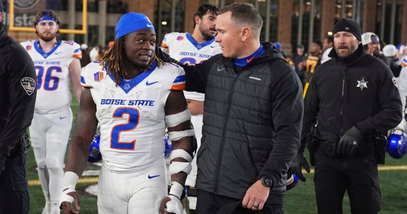 Boise State head coach Spencer Danielson chats with running back Ashton Jeanty (2) after an NCAA college football game against Wyoming Nov. 23 in Laramie, Wyoming.