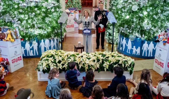 First lady Jill Biden, accompanied by Lt. Gen. Leonard Anderson IV, Commander of the U.S. Marine Corps Reserve, speaks during a Toys for Tots event in the East Room of the White House Friday