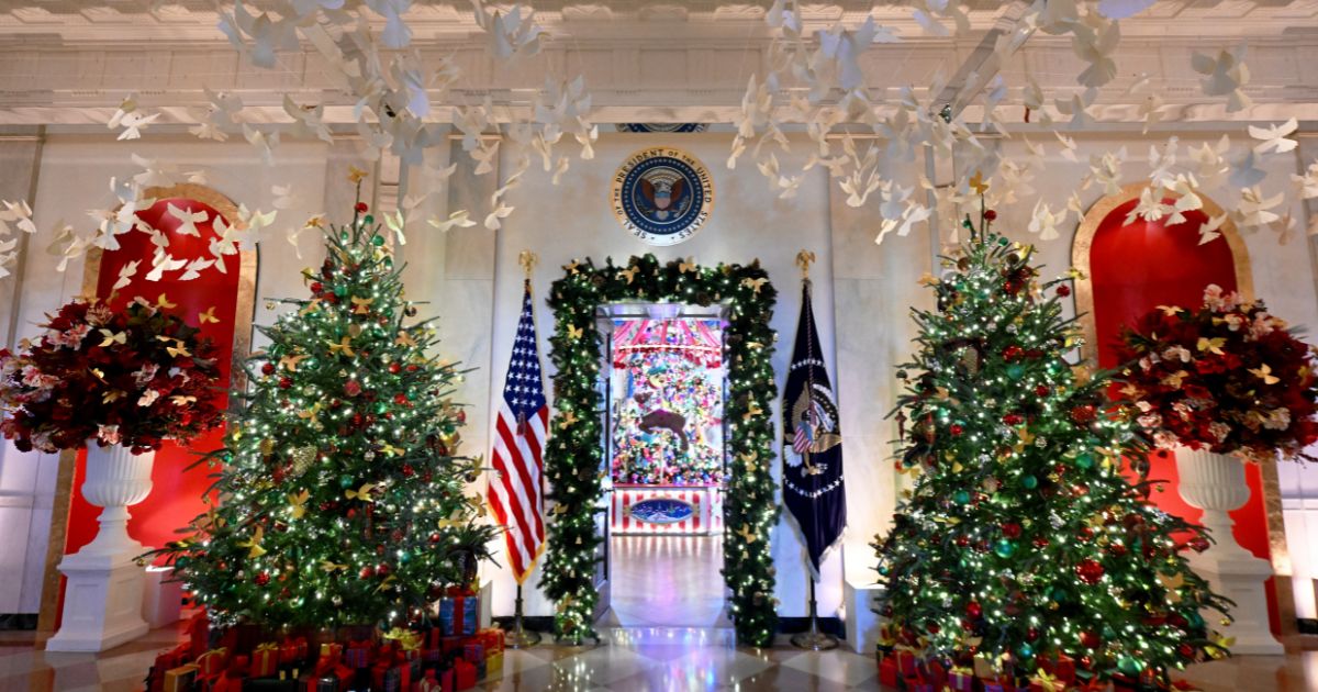 The Seal of the President of the United States sits high above Christmas decorations in the Cross Hall during the 2024 White House Holiday media preview in Washington, D.C., on Monday.