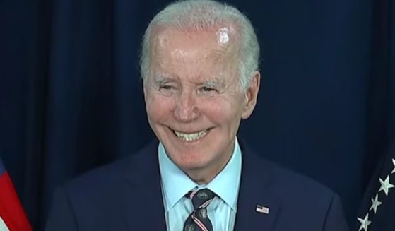 President Joe Biden smiles while answering a reporter's question about President-elect Donald Trump following his remarks on the death of former President Jimmy Carter on Sunday.