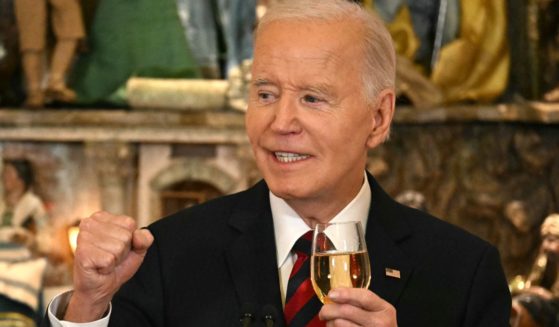 President Joe Biden makes a toast as he speaks at a Christmas for All Dinner in Celebration of Unity, America, and Special Olympics, in the East Room of the White House in Washington, D.C., on Tuesday.