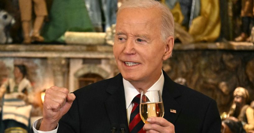 President Joe Biden makes a toast as he speaks at a Christmas for All Dinner in Celebration of Unity, America, and Special Olympics, in the East Room of the White House in Washington, D.C., on Tuesday.