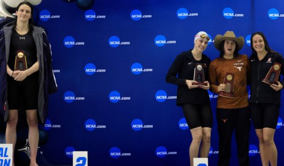 Lia Thomas, left, stands on the podium after winning the 500-yard freestyle as other female medalists Emma Weyant, second from left; Erica Sullivan, second from right,; and Brooke Forde, right, pose for a photo at the NCAA Division I Women's Swimming & Diving Championship in Atlanta, Georgia, on March 17, 2022.