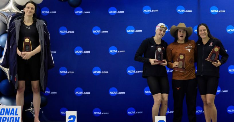 Lia Thomas, left, stands on the podium after winning the 500-yard freestyle as other female medalists Emma Weyant, second from left; Erica Sullivan, second from right,; and Brooke Forde, right, pose for a photo at the NCAA Division I Women's Swimming & Diving Championship in Atlanta, Georgia, on March 17, 2022.