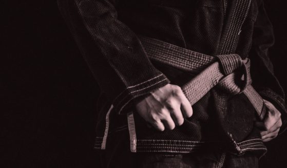 This stock image shows a Brazilian Jiu-Jitsu fighter holding onto his belt.