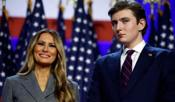 Former and future first lady Melania Trump, left, and Barron Trump, right, look on as President-elect Donald Trump speaks during an election night event in West Palm Beach, Florida, on Nov. 6.