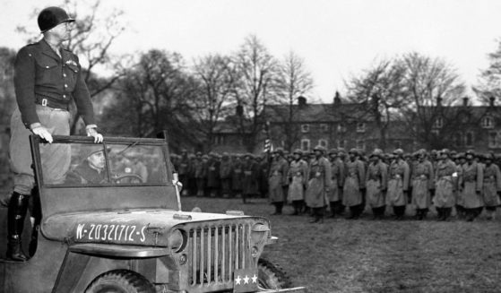 Standing in a jeep, Lt. Gen. George S. Patton reviews troops in Northern Ireland on April 26, 1944.