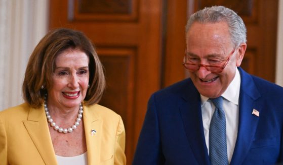 Rep. Nancy Pelosi, left, and Senate Majority Leader Chuck Schumer, right, attend an event on the anniversary of the Inflation Reduction Act in the East Room of the White House in Washington, D.C., on Aug. 16, 2023.