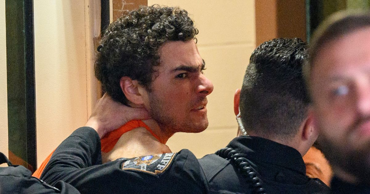 Suspected shooter Luigi Mangione is led into the Blair County Courthouse for an extradition hearing December 10, 2024 in Hollidaysburg, Pennsylvania.