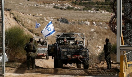 Israeli military vehicles cross the fence as they return from the buffer zone with Syria, near the Druze village of Majdal Shams in the Israel-annexed Golan Heights on December 10, 2024.