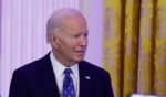 U.S. President Joe Biden speaks as Rabbi Elliott Cosgrove of Park Avenue Synagogue in New York City looks on during a Hanukkah holiday reception in the East Room of the White House on December 16, 2024 in Washington, DC.