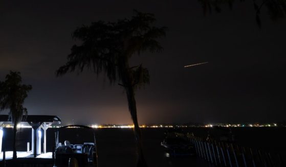 A meteor streaks across the sky during the Perseid meteor shower during the late evening on August 12, 2023 in White Lake, North Carolina.