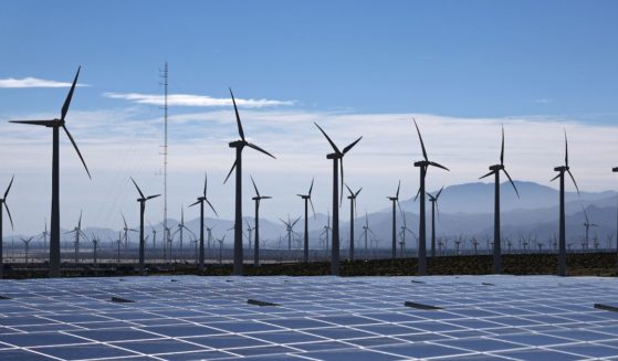 Wind turbines operate at a wind farm near solar panels on March 06, 2024 near Palm Springs, California.