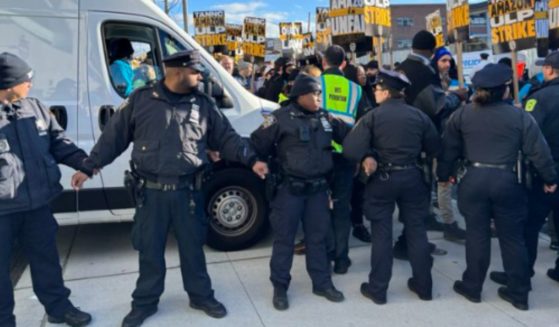 Photos and video shared on social media showed police officers blocking the path of striking Amazon workers.