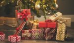 This stock photo shows wrapped Christmas presents under the tree.