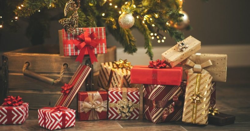 This stock photo shows wrapped Christmas presents under the tree.