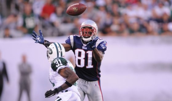 Randy Moss #81 of the New England Patriots goes up to catch a pass in a game against the New York Jets on Sept. 19, 2010.