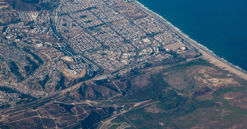 The city of Tijuana, Mexico, top, and San Diego, bottom, are separated by the United States-Mexico border at the coast of the Pacific Ocean in an aerial view on Aug. 24.