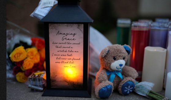 Flowers and candles are placed outside the Abundant Life Christian School Tuesday, Dec. 17, 2024 in Madison, Wisconsin, following a shooting on Monday.