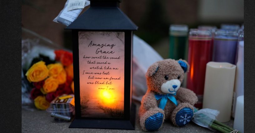 Flowers and candles are placed outside the Abundant Life Christian School Tuesday, Dec. 17, 2024 in Madison, Wisconsin, following a shooting on Monday.