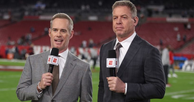 ESPN announcers Joe Buck, left, and Troy Aikman, right, stand on the sideline of the NFC Wild Card Playoff Game in Tampa, Florida, on Jan. 16.