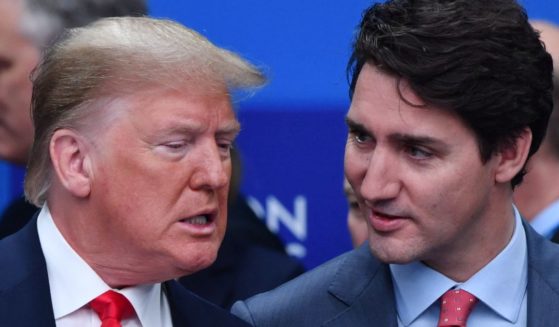 Then-President Donald Trump, left, and Canadian Prime Minister Justin Trudeau, right, are pictured during the plenary session of the NATO summit in London, England, on Dec. 4, 2019.