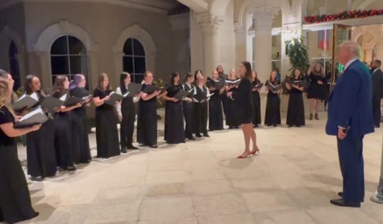 President-elect Donald Trump listens to a choir perform "Silent Night" at Trump International Golf Club in West Palm Beach, Florida, on Sunday.