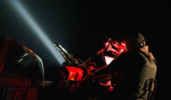 A Ukrainian soldier of the mobile air defense unit sits behind an anti-UAV machine gun tracking Russian drones in the sky during night patrol in Chernihiv Oblast, Ukraine, on Dec. 2.