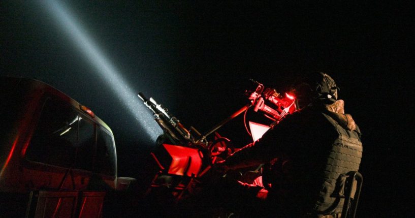 A Ukrainian soldier of the mobile air defense unit sits behind an anti-UAV machine gun tracking Russian drones in the sky during night patrol in Chernihiv Oblast, Ukraine, on Dec. 2.