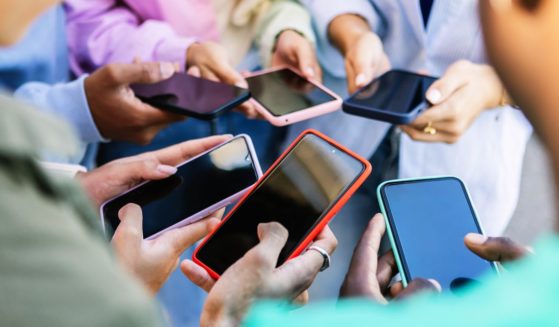 This Getty stock image shows a number of people using smart phones.