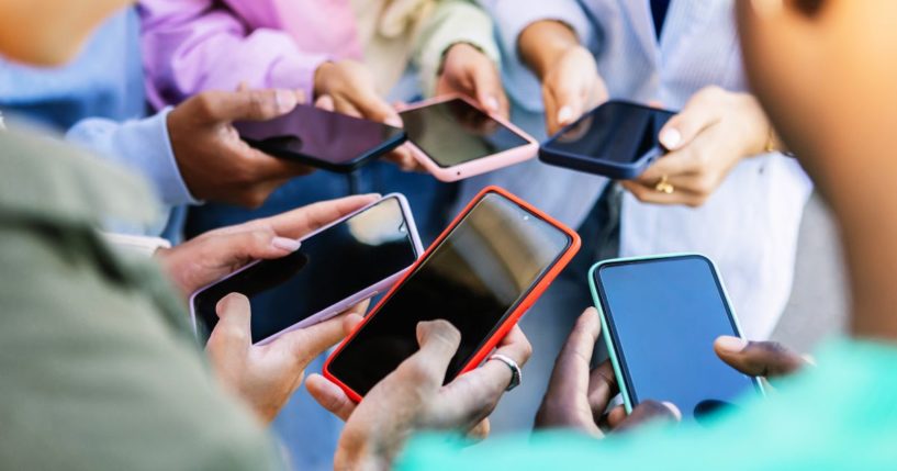 This Getty stock image shows a number of people using smart phones.