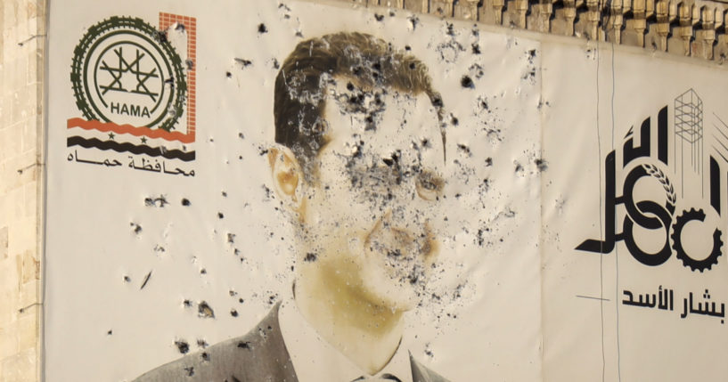 An image of Syrian President Bashar Assad, riddled with bullets, is seen on the facade of the provincial government office in the aftermath of the opposition's takeover of Hama, Syria, on Dec. 6.