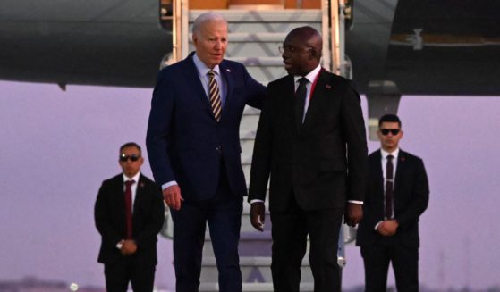 US President Joe Biden (3rd R) walks on the red carpet next to Angola Foreign Affairs Minister Tete Antonio (2nd R) upon his arrival at the Quatro de Fevereiro Luanda International Airport in Luanda on December 2, 2024.