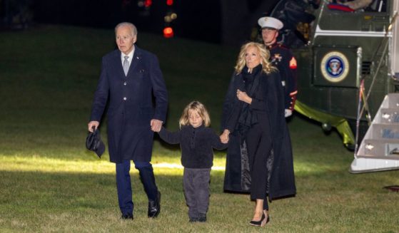 U.S. President Joe Biden, grandson Beau Biden and first lady Jill Biden walk off Marine One on the south lawn at the White House on December 19, 2024 in Washington, DC.